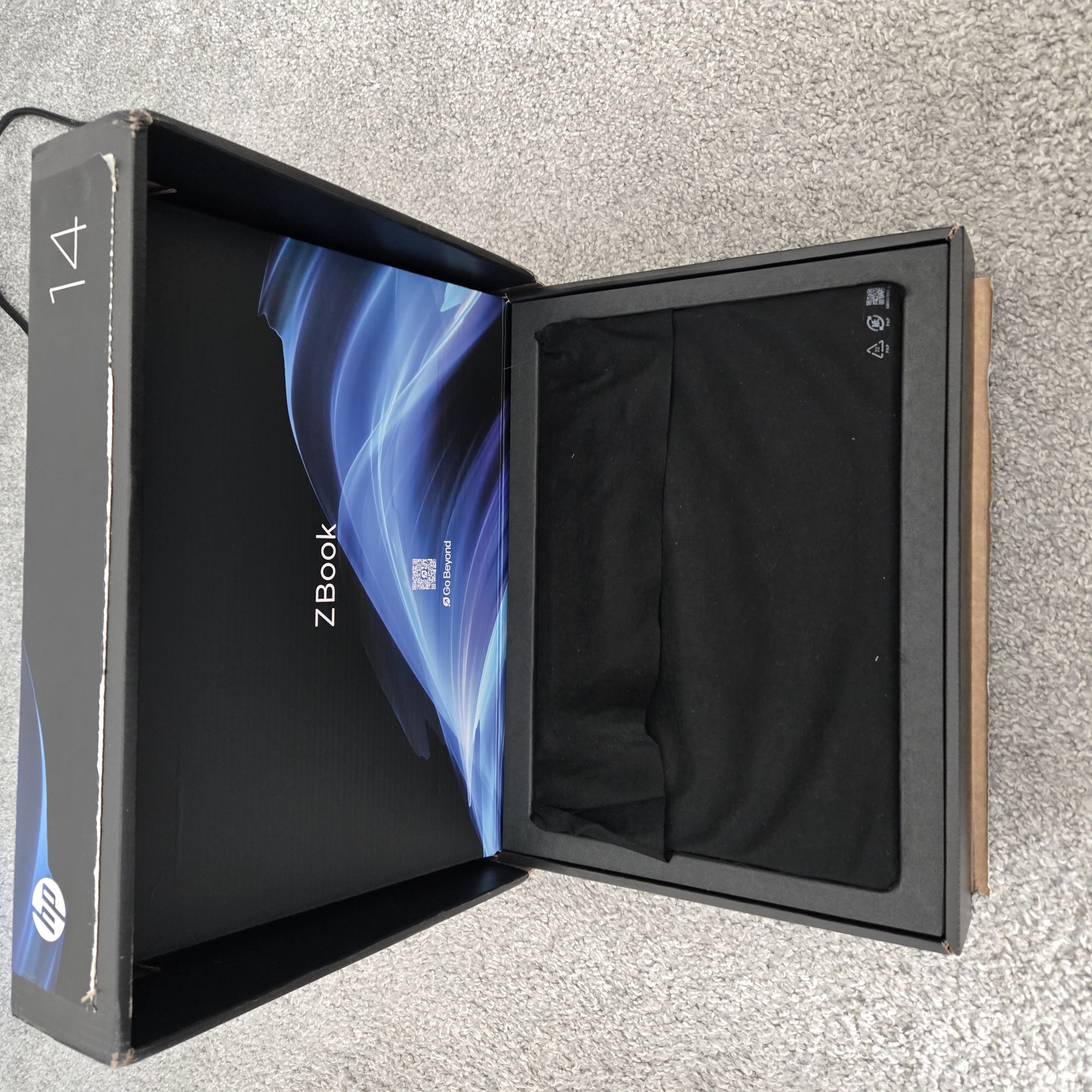 Shipping box used for the HP ZBook laptop, showing thin cardboard with minimal internal padding